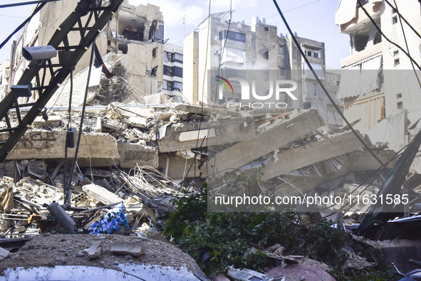 Smoke rises from a building destroyed by an Israeli airstrike as journalists and local residents visit during a press tour in Beirut, Lebano...