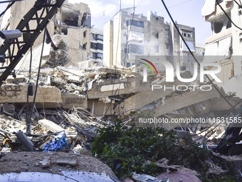 Smoke rises from a building destroyed by an Israeli airstrike as journalists and local residents visit during a press tour in Beirut, Lebano...