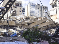 Smoke rises from a building destroyed by an Israeli airstrike as journalists and local residents visit during a press tour in Beirut, Lebano...