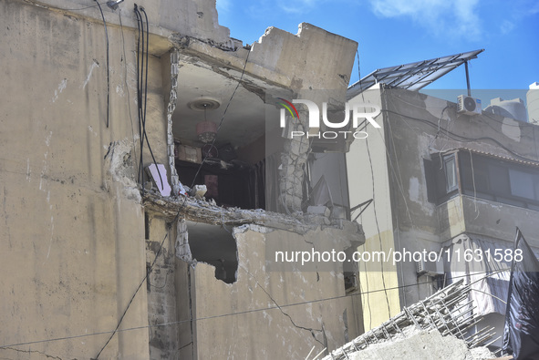 Smoke rises from a building destroyed by an Israeli airstrike as journalists and local residents visit during a press tour in Beirut, Lebano...