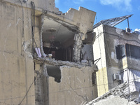 Smoke rises from a building destroyed by an Israeli airstrike as journalists and local residents visit during a press tour in Beirut, Lebano...