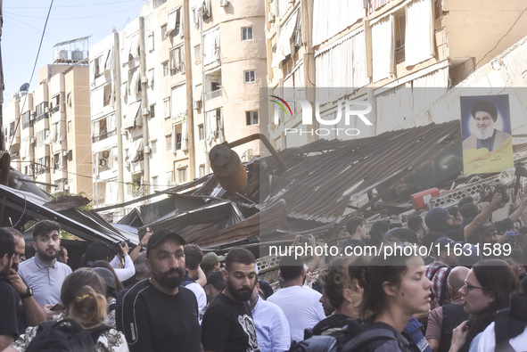 Smoke rises from a building destroyed by an Israeli airstrike as journalists and local residents visit during a press tour in Beirut, Lebano...