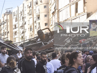 Smoke rises from a building destroyed by an Israeli airstrike as journalists and local residents visit during a press tour in Beirut, Lebano...