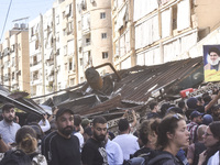 Smoke rises from a building destroyed by an Israeli airstrike as journalists and local residents visit during a press tour in Beirut, Lebano...