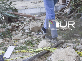 Smoke rises from a building destroyed by an Israeli airstrike as journalists and local residents visit during a press tour in Beirut, Lebano...