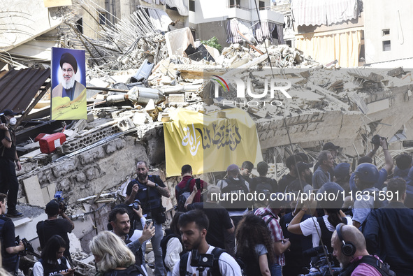 Smoke rises from a building destroyed by an Israeli airstrike as journalists and local residents visit during a press tour in Beirut, Lebano...