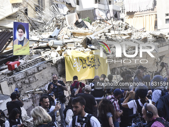 Smoke rises from a building destroyed by an Israeli airstrike as journalists and local residents visit during a press tour in Beirut, Lebano...