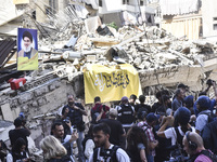 Smoke rises from a building destroyed by an Israeli airstrike as journalists and local residents visit during a press tour in Beirut, Lebano...