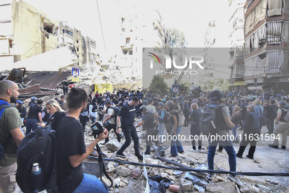 Smoke rises from a building destroyed by an Israeli airstrike as journalists and local residents visit during a press tour in Beirut, Lebano...