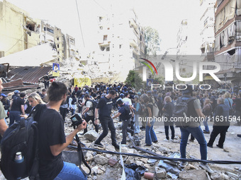 Smoke rises from a building destroyed by an Israeli airstrike as journalists and local residents visit during a press tour in Beirut, Lebano...