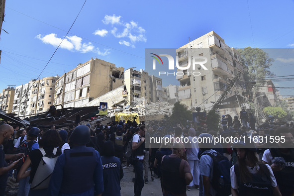 Smoke rises from a building destroyed by an Israeli airstrike as journalists and local residents visit during a press tour in Beirut, Lebano...