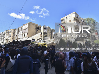 Smoke rises from a building destroyed by an Israeli airstrike as journalists and local residents visit during a press tour in Beirut, Lebano...