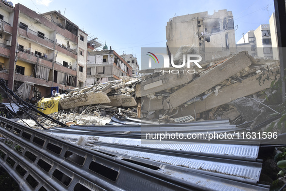 Smoke rises from a building destroyed by an Israeli airstrike as journalists and local residents visit during a press tour in Beirut, Lebano...