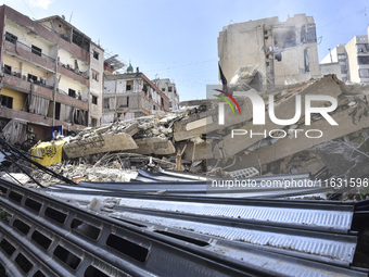 Smoke rises from a building destroyed by an Israeli airstrike as journalists and local residents visit during a press tour in Beirut, Lebano...