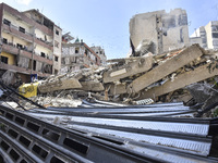 Smoke rises from a building destroyed by an Israeli airstrike as journalists and local residents visit during a press tour in Beirut, Lebano...