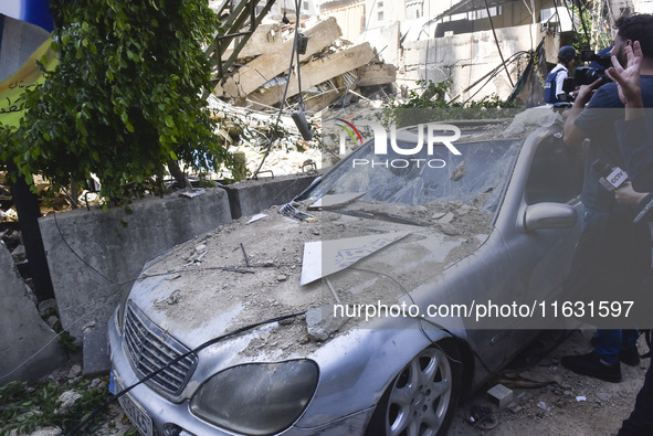 Smoke rises from a building destroyed by an Israeli airstrike as journalists and local residents visit during a press tour in Beirut, Lebano...