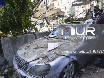 Smoke rises from a building destroyed by an Israeli airstrike as journalists and local residents visit during a press tour in Beirut, Lebano...