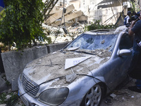 Smoke rises from a building destroyed by an Israeli airstrike as journalists and local residents visit during a press tour in Beirut, Lebano...