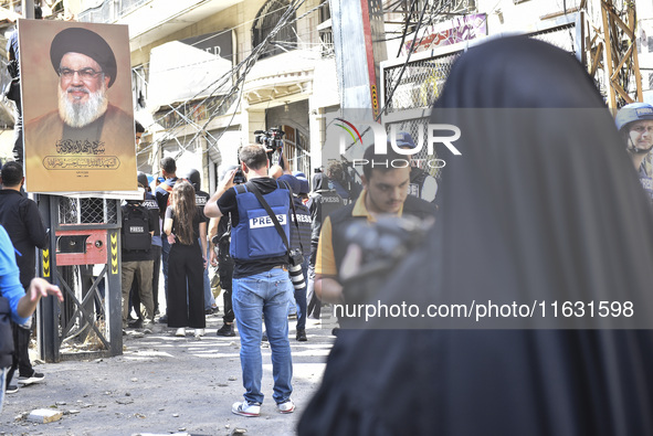 Smoke rises from a building destroyed by an Israeli airstrike as journalists and local residents visit during a press tour in Beirut, Lebano...