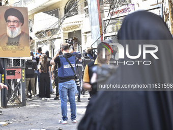 Smoke rises from a building destroyed by an Israeli airstrike as journalists and local residents visit during a press tour in Beirut, Lebano...