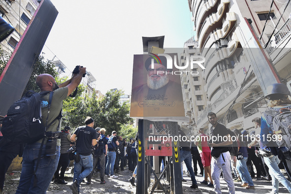 Smoke rises from a building destroyed by an Israeli airstrike as journalists and local residents visit during a press tour in Beirut, Lebano...