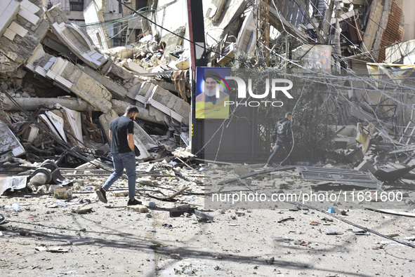 Smoke rises from a building destroyed by an Israeli airstrike as journalists and local residents visit during a press tour in Beirut, Lebano...