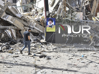 Smoke rises from a building destroyed by an Israeli airstrike as journalists and local residents visit during a press tour in Beirut, Lebano...