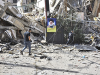 Smoke rises from a building destroyed by an Israeli airstrike as journalists and local residents visit during a press tour in Beirut, Lebano...