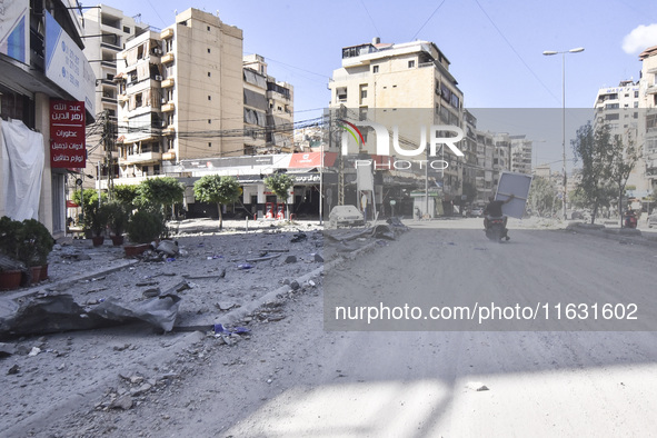 Smoke rises from a building destroyed by an Israeli airstrike as journalists and local residents visit during a press tour in Beirut, Lebano...