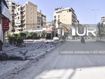 Smoke rises from a building destroyed by an Israeli airstrike as journalists and local residents visit during a press tour in Beirut, Lebano...