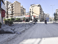 Smoke rises from a building destroyed by an Israeli airstrike as journalists and local residents visit during a press tour in Beirut, Lebano...