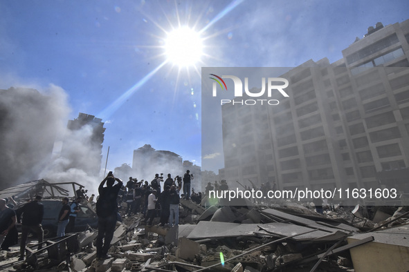 Smoke rises from a building destroyed by an Israeli airstrike as journalists and local residents visit during a press tour in Beirut, Lebano...