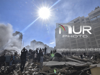 Smoke rises from a building destroyed by an Israeli airstrike as journalists and local residents visit during a press tour in Beirut, Lebano...