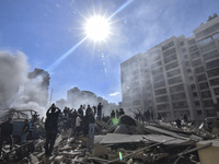 Smoke rises from a building destroyed by an Israeli airstrike as journalists and local residents visit during a press tour in Beirut, Lebano...