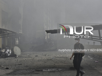 Smoke rises from a building destroyed by an Israeli airstrike as journalists and local residents visit during a press tour in Beirut, Lebano...