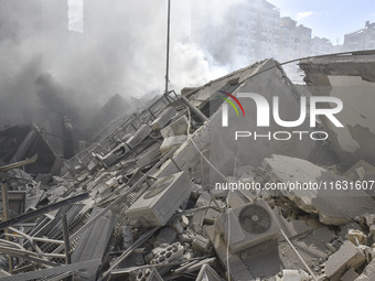 Smoke rises from a building destroyed by an Israeli airstrike as journalists and local residents visit during a press tour in Beirut, Lebano...