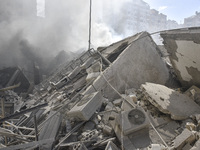 Smoke rises from a building destroyed by an Israeli airstrike as journalists and local residents visit during a press tour in Beirut, Lebano...