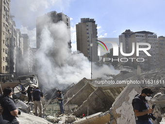 Smoke rises from a building destroyed by an Israeli airstrike as journalists and local residents visit during a press tour in Beirut, Lebano...