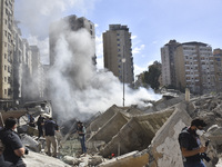 Smoke rises from a building destroyed by an Israeli airstrike as journalists and local residents visit during a press tour in Beirut, Lebano...