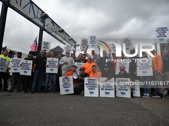 Longshoremen carry signs and demonstrate to make their voices heard outside Red Hook Terminal in Brooklyn, New York, United States, on Octob...