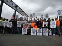 Longshoremen carry signs and demonstrate to make their voices heard outside Red Hook Terminal in Brooklyn, New York, United States, on Octob...