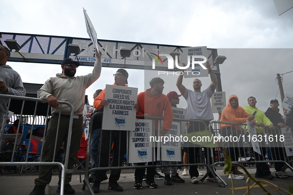 Longshoremen carry signs and demonstrate to make their voices heard outside Red Hook Terminal in Brooklyn, New York, United States, on Octob...