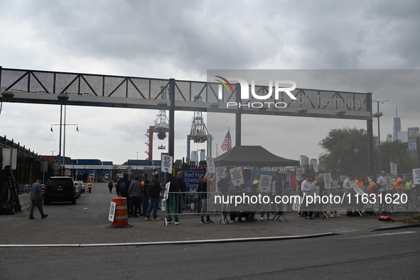 Longshoremen carry signs and demonstrate to make their voices heard outside Red Hook Terminal in Brooklyn, New York, United States, on Octob...