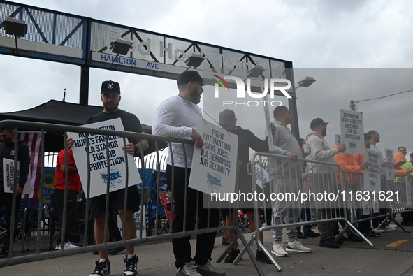 Longshoremen carry signs and demonstrate to make their voices heard outside Red Hook Terminal in Brooklyn, New York, United States, on Octob...