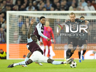 Harry Kane centre-forward of Bayern Munich and England and Amadou Onana defensive midfield of Aston Villa and Belgium compete for the ball d...