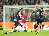 Harry Kane centre-forward of Bayern Munich and England and Amadou Onana defensive midfield of Aston Villa and Belgium compete for the ball d...