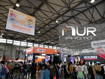 Visitors look at a handmade model on display at the Wonder Festival 2024 in Shanghai, China, on October 2, 2024. (