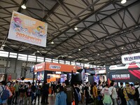 Visitors look at a handmade model on display at the Wonder Festival 2024 in Shanghai, China, on October 2, 2024. (