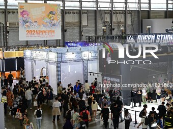 Visitors look at a handmade model on display at the Wonder Festival 2024 in Shanghai, China, on October 2, 2024. (