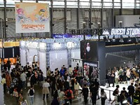 Visitors look at a handmade model on display at the Wonder Festival 2024 in Shanghai, China, on October 2, 2024. (